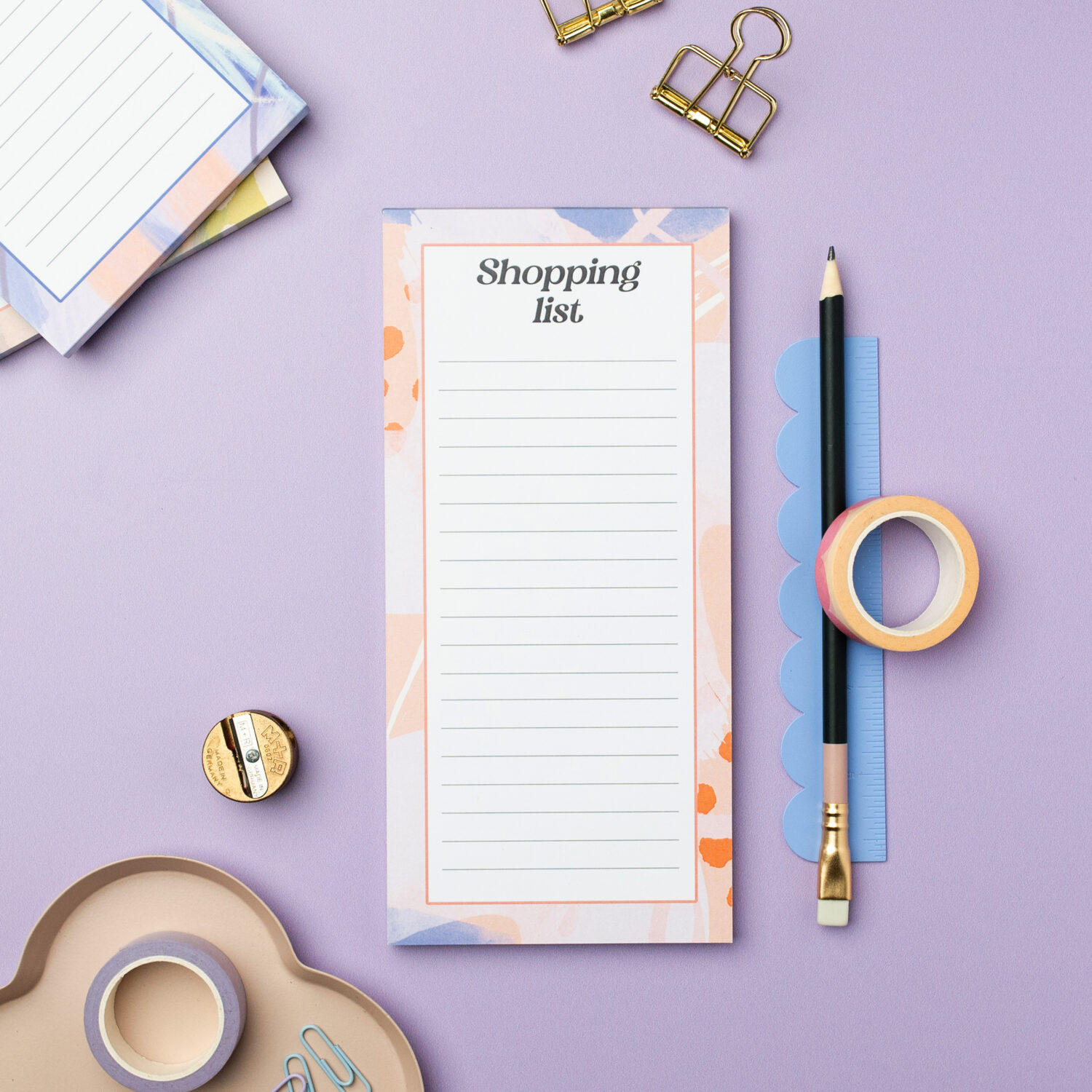 shopping list notepad with orange and ink border and lines