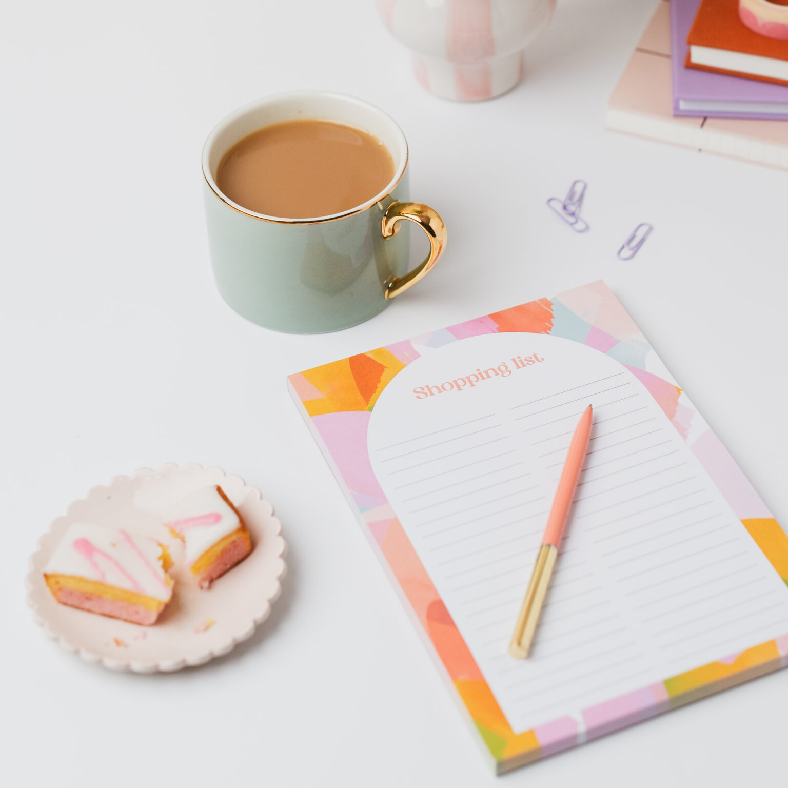 food shopping list note pad with tea and cake ready to write list down